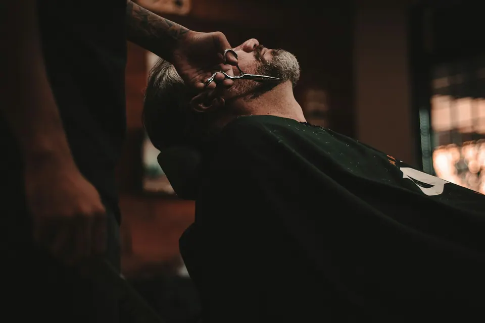 Barber shaping a beard with care